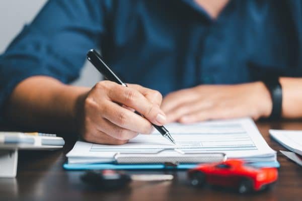 man making a checklist of step by step guide to buying real estate investment