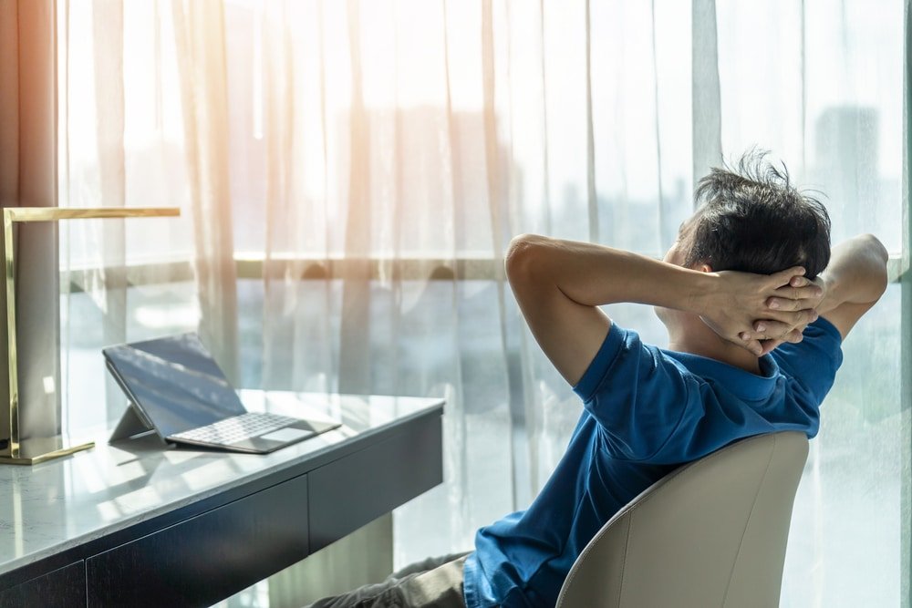 man relaxing after working in home office