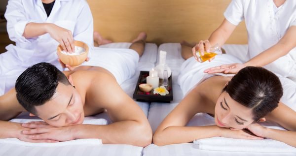 a photo of two people getting a couple massage.